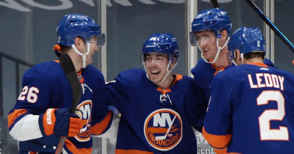 Three men in blue and orange hockey uniforms.