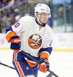 A man in an orange and white hockey uniform.