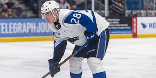 A hockey player is standing on the ice.