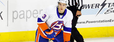 A hockey player in white and orange jersey.