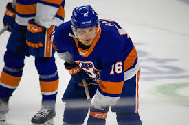 A hockey player crouches on the ice