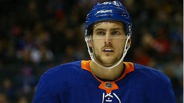 A close up of a hockey player with his face in the air.