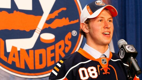 A man in an orange and white hockey uniform.