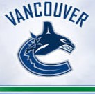 A vancouver canucks logo on the side of a white and blue uniform.